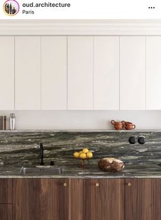 an image of a kitchen setting with marble counter tops and wooden cabinets in the background