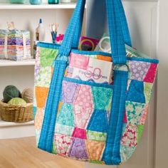 a colorful bag hanging from the side of a white wall next to a book shelf