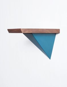 a wooden shelf with two blue triangles on it