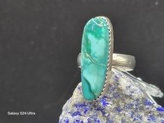 This handcrafted sterling silver jewelry showcases a green fox turquoise ring, a gemstone treasure both rare and enchanting. It boasts unique and exceedingly rare turquoise from the Cortez mine, characterized by gem-grade green hues from the Fox mine in Lander County, Nevada. As one of the oldest and most prolific mines in the United States, the Cortez mine's closure has rendered its turquoise highly sought-after by collectors. The ring features a captivating swirl of deep and pale green colors. Green Turquoise Ring With Large Stone As Gift, Green Turquoise Ring With Large Stone For Gift, Southwestern Green Turquoise Ring With Large Stone, Southwestern Style Green Turquoise Ring With Large Stone, Green Turquoise Ring With Natural Stones, Southwestern Style Green Turquoise Ring As Gift, Unique Green Turquoise Ring With Large Stone, Untreated Green Turquoise Bohemian Ring, Unique Untreated Turquoise Emerald Ring