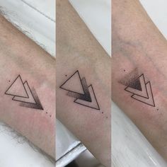 three different tattoos that are on the arm and one has a triangle tattoo on it