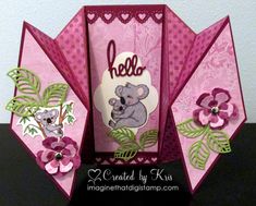 a pink card with an image of a koala bear and flowers on the front