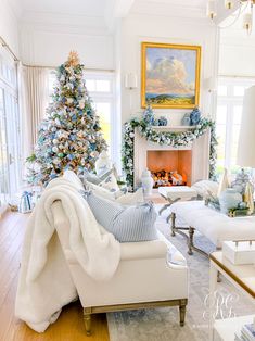 a living room filled with furniture and a christmas tree in front of a fire place