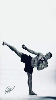 a man doing a kickbox pose with his leg in the air and one arm out