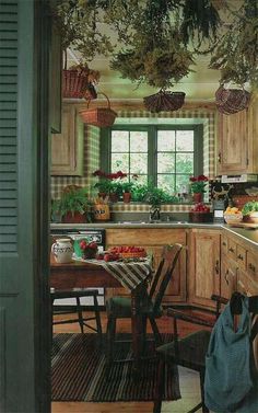 a kitchen filled with lots of wooden furniture and potted plants hanging from the ceiling