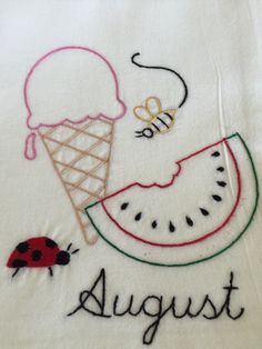 an embroidered t - shirt with the words august and a watermelon slice