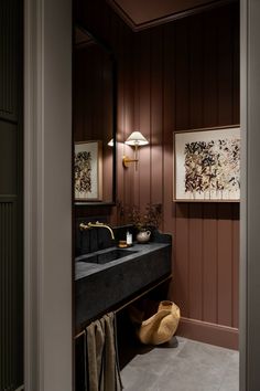 a bathroom with a black sink and brown walls