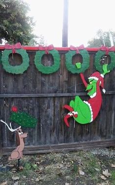 the grinch is hanging on the fence