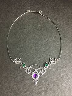 I've fabricated a Celtic Knot statement neck ring, in 925 sterling silver, and I will set your choice of an 8mm cabochon gemstone within the drop down menu. For perspective, I've shown this with amethyst, but you can choose from a varied selection if you prefer. I've made the choker approximately 14.5-15 inches but please specify if you need it longer or shorter as I will accommodate. Also, included will be two, 5mm emerald faceted gems to compliment the piece. If you prefer another color, pleas Sterling Silver Jewelry With Unique Variations For Gifting, Formal Sterling Silver Wire Wrapped Jewelry, Unique Sterling Silver Jewelry As Gift, Sterling Silver Soldered Jewelry For Weddings, Unique Sterling Silver Necklaces With Jewels, Unique Sterling Silver Necklace With Jewels, Handmade Sterling Silver Necklace For Wedding, Soldered Pendant Jewelry For Wedding, Gems Necklace