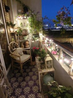 the balcony is decorated with lights and potted plants