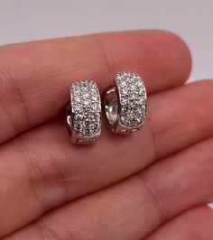 These are beautiful diamond huggie earrings set with beautiful Natural Diamonds in Solid 14Kt Gold.  The diamonds sparkles and shines beautifully. Diamond info: Diamonds: 38 Diamond cut: Round Diamond weight: 0.76 carats Color: G-H Clarity: SI2 Metal info: Metal: 14Kt Gold Metal Weight: 6.5 Grams Earring Size: 11.40mm (0.448 inches) x 12.35mm (0.486 inches) x 5.50mm(0.216 inches) 2mm thickness  WE HAVE MORE BEAUTIFUL DIAMOND JEWELRY THAT YOU CAN SEE IN OUR STORE AND IS ALL AVAILABLE IN WHITE, YELLOW AND ROSE GOLD. Want to see more photos and videos of my jewelry and how its made? Follow us on Instagram instagram.com/elizabethjewelryinc @elizabethjewelryinc Follow us on Facebook Facebook.com/Elizabethjewelryinc Sparkling Diamond Hoop Earrings As Gift, Sparkling Diamond Hoop Earrings For Gift, Dazzling Pave Set Hoop Earrings For Anniversary, Dazzling Small Hoop White Gold Earrings, Dazzling White Gold Small Hoop Earrings, Luxury Diamond Huggie Earrings In Diamond White, Luxury Diamond White Diamond Huggie Earrings, Fine Jewelry Sparkling Diamond Earrings, Dazzling Diamond White Small Hoop Earrings