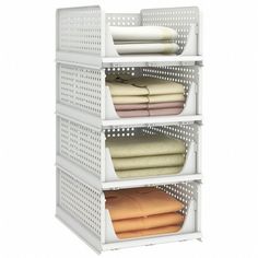 three tiered storage rack with folded sheets and blankets on top of each shelf in front of a white background