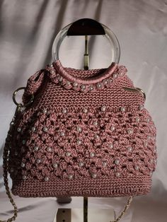 Pearl Pink Knitted Handbag with pink shoulder strap Introducing our exquisite Pearl Pink Knitted Handbag with pink shoulder strapp. This unique purse is a perfect blend of style and craftsmanship, meticulously crafted. The purse features a beautifully knitted design, adding a touch of elegance to any outfit. The intricate details highlight the skill and dedication put into creating this one-of-a-kind accessory. The silver shoulder strap adds a modern and chic element, allowing for easy and comfo Elegant Handmade Pink Shoulder Bag, Elegant Pink Handmade Shoulder Bag, Pink Crochet Satchel Bag With Adjustable Strap, Pink Satchel Crochet Bag With Adjustable Strap, Elegant Top Handle Crochet Shoulder Bag, Elegant Crochet Top Handle Shoulder Bag, Pink Double Handle Crochet Bag For Daily Use, Pink Crochet Bag With Double Handle For Daily Use, Pink Handheld Shoulder Bag With Braided Handles