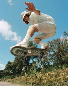 a man in the air on a skateboard doing a trick with his hands and feet