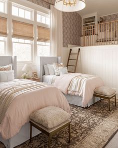 two beds in a bedroom with beige and white decor