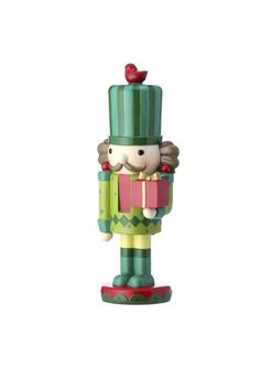 a nutcracker figurine holding a gift box