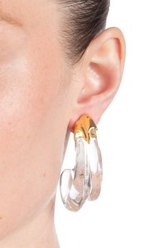 Hand-sculpted Lucite hoop earrings in a clear-liquid silhouette glimmer in the light, while the 14-karat gold-plated molten-inspired detail adds rich texture. 2" drop; 3/4" width Post back Lucite/14k-gold plate Imported Modern Clear Earrings For Formal Occasions, Modern Small Hoop Jewelry In Clear, Modern Small Hoop Clear Jewelry, Modern Clear Small Hoop Jewelry, Modern Small Hoop Clear Earrings, Modern Clear Hoop Earrings For Pierced Ears, Modern Clear Hoop Earrings, Modern Lucite Hoop Earrings, Formal Clear Lucite Jewelry