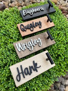 three wooden signs that say thank, hugger, nursery and hank on top of some rocks