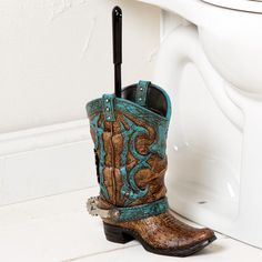 a pair of cowboy boots sitting next to a toilet