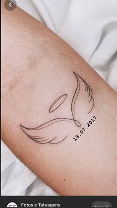 a close up of a person's arm with a bird tattoo on the arm