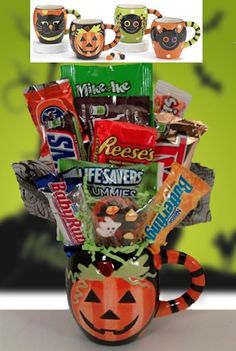 a coffee mug filled with candy and candies, halloween themed items in front of a green background