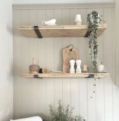 two wooden shelves above a sink in a kitchen