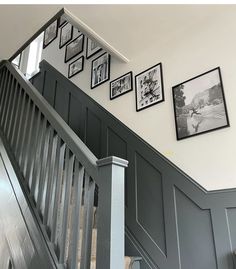 stairs with pictures on the wall above them