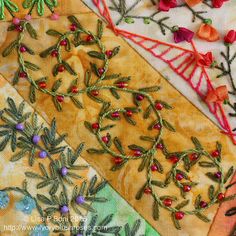 an assortment of embroidered fabric with flowers and leaves on them, including one in the center