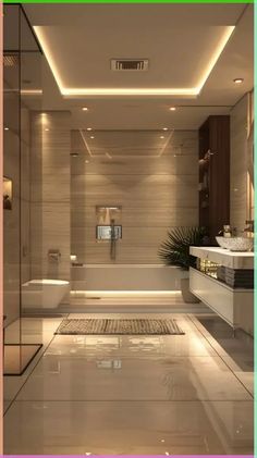 a bathroom with a tub, toilet and sink in it's center wall is illuminated by recessed lighting