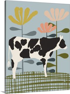 a black and white cow standing in front of flowers