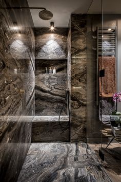 a modern bathroom with marble walls and flooring