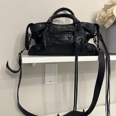 Balenciaga Classic City Bag Very Good Condition No Scratches, Tears Or Wear On Leather Comes With Detachable Shoulder Strap *Some Wear On Metal Hardware Original Mirror Not Included - I Lost It This Is An Authentic Balenciaga Agneau Classic Hardware S City In Black. This Chic Tote Is Crafted Of Agneau Lambskin Distressed Leather In Black And Features Rolled Leather Top Handles With Handwoven Whipstitch Detail, An Optional Shoulder Strap The Top Zipper Opens To A Black Fabric Interior. Balenciaga Small City Bag, Balenciaga Small City, Balenciaga Classic City Bag, Balenciaga Classic City, Balenciaga Handbags, Small City, Balenciaga Bag, City Bag, Distressed Leather