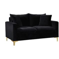 a black couch with gold legs and pillows