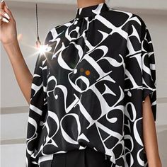 New With Tags Chic And Savvy Graphic Letter Print Tie Back Blouse. Relaxed Fit, Slightly Oversized Dolman Style Sleeved With A Comfortable And Sophisticated Asymmetrical Hem. Stand Collar Allover Lavishly Print. Shirt Sleeves Non-Stretch. Machine Wash Or Professional Dry Clean Elegant Black Blouse With Graphic Print, Chic Black Blouse With Graphic Print, Hogwarts Shirt, Tie Back Blouse, Paris Black And White, Blue White Top, Weird Shirts, Paris Woman, Purple Blouse