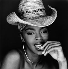 a woman wearing a straw hat with her hand on her mouth