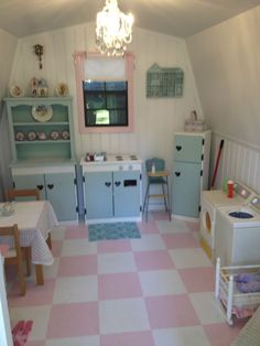 a pink and white checkered floor in a child's playroom with lots of furniture