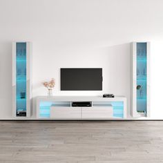 a living room with white furniture and blue lights on the tv stand in front of it