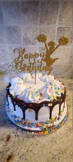 a birthday cake with white frosting and sprinkles