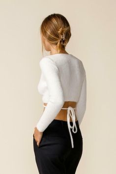 Final Sale - Get it before it's gone! Get a cute fall look with the Mimi White Wrap Cropped Sweater Top and high-waisted jeans! White ribbed Medium-weight stretch knit shapes this sweater top that has long sleeves and a surplice neckline that flows into a wrapping bodice. Two long straps tie together at the back below the cropped hem. Style with your favorite 90's jeans for a cute fall look! DETAILS & CARE Viscose. Hand wash cold. Imported. Stretch Ribbed Cropped Sweater For Fall, Trendy White Knit Top For Fall, Trendy Ribbed Knit Top For Fall, White Stretch Cropped Sweater For Fall, Chic Fitted Cropped Sweater For Fall, Fitted White Soft Knit Cropped Sweater, Spring Cropped Sweater With Long Sleeves, Spring Long Sleeve Cropped Sweater With Cozy Fit, Spring Cropped Long Sleeve Sweater In Cozy Fit