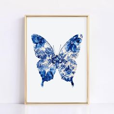 a blue and white butterfly print hanging on a wall