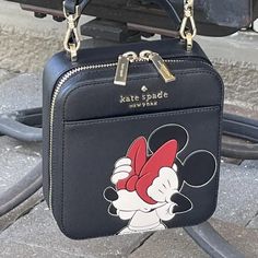 Kate Spade Disney Minnie Mouse Black Red Bow Vanity Daisy Crossbody Shoulder Bag Price Is Strictly Firm Approximate Measurements: 6" (L) X 6" (H) X 2.5" (D) Gorgeous Black Leather With Minnie Mouse Light Gold Tone Hardware Top Handle Plus Adjustable Shoulder/Crossbody Strap With 20" - 26" Drop Double Zip Closure Kate Spade Signature Name On Front Of Bag Slip Pocket On Front Of Bag Interior Is Lined In Kate Spade Signature Fabric With 3 Card Slots Approximate Measurements: 6.5" (L) X 6" (H) X 2.5 Kate Spade Minnie Mouse Purse, Minnie Mouse Purse, Mickey Mouse Shoes, Holiday Finds, Kate Spade Minnie Mouse, Purse Collection, Kate Spade Disney, Disney Bags, Bag Interior