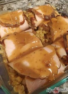 a glass dish filled with meat covered in gravy