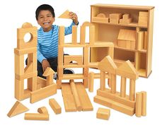 a young boy playing with wooden toys