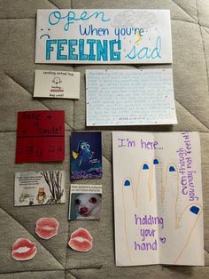 some paper and magnets are laying on the floor with words, pictures, and other items