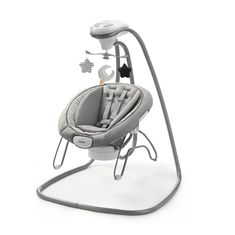 a baby swing that is sitting on top of a white surface with an electronic device attached to it