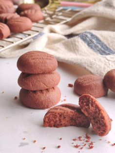 several cookies are stacked on top of each other near a computer keyboard and napkins