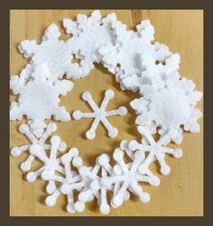 snowflakes are arranged on a wooden surface