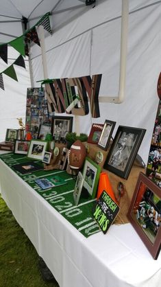 a table topped with pictures and photos under a tent