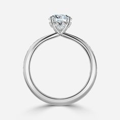 a white gold engagement ring with a single diamond