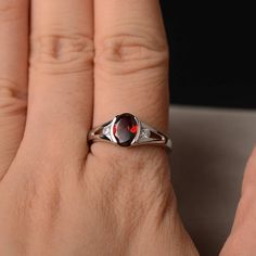 This is a gorgeous handmade creation. Its beauty is its simplicity & Elegance. The 6*8mm oval shape faceted natural garnet is crafted in solid sterling silver and with rhodium plated. All item is sent in a beautiful gift box If you have any idea of design your ring,pls contact me directly. You can realize more lovely stuff clicking the link https://www.etsy.com/shop/knightjewelry?refshopsection_shophome_leftnav Please leave the correct address and you phone number for delivering successfully Oval Garnet Birthstone Ring For Anniversary, Oval Garnet Rings For Anniversary, Oval Garnet Ruby Ring As Gift, Oval Garnet Birthstone Ring, Elegant Oval Garnet Birthstone Ring, Oval Garnet Birthstone Ring As Gift, Silver Garnet Engagement Ring, Oval Cabochon Garnet Rings For Anniversary, Oval Garnet Rings As Gift